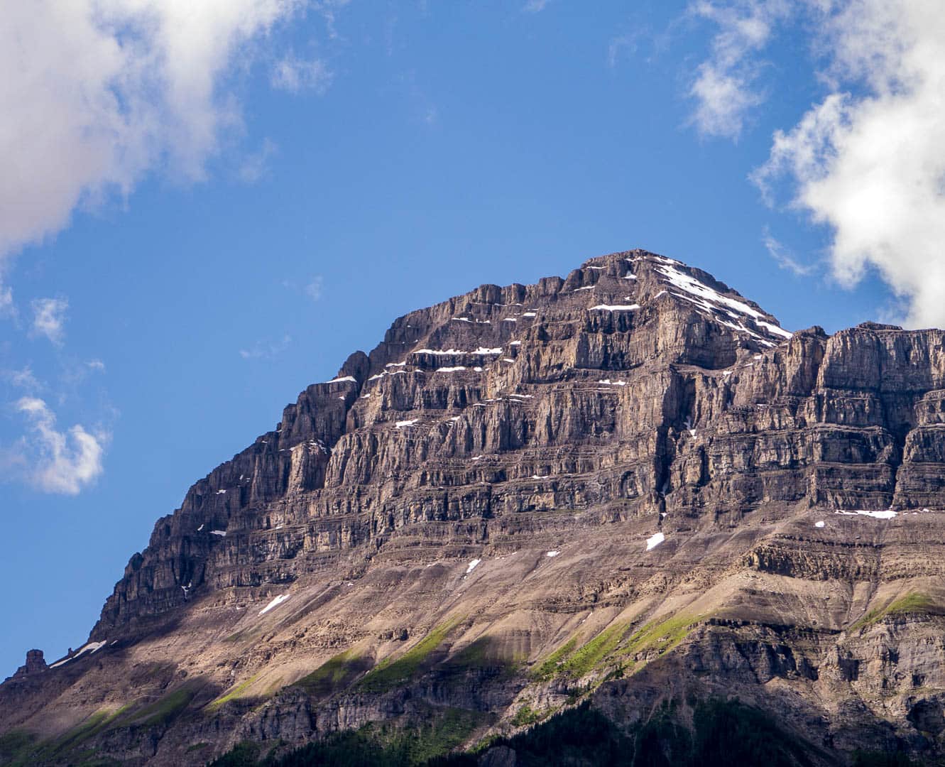 Layered sedimentary rock layers in the cliffside of the mountian