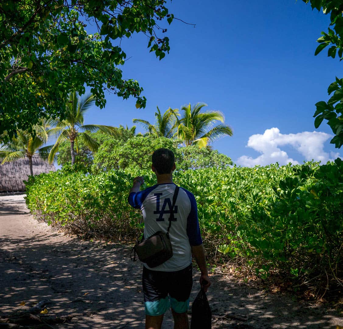 A friend pointing down a lush path