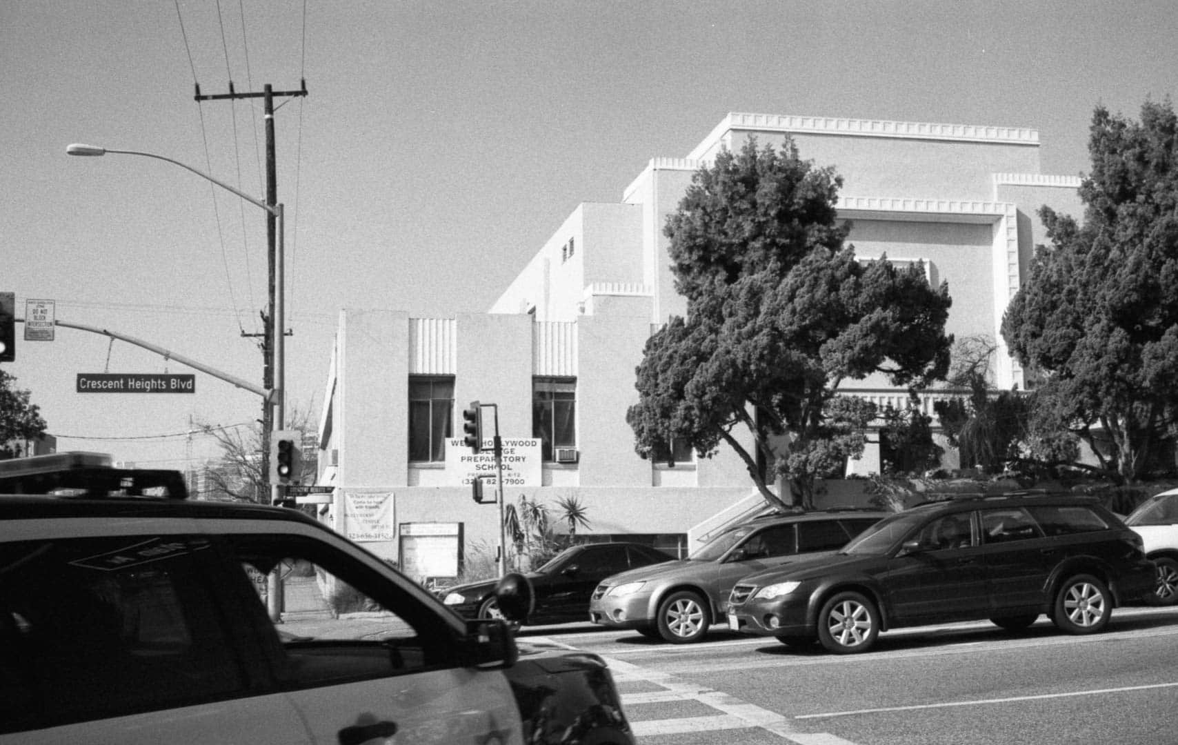 LAPD car turning the corner into the frame of an intersection