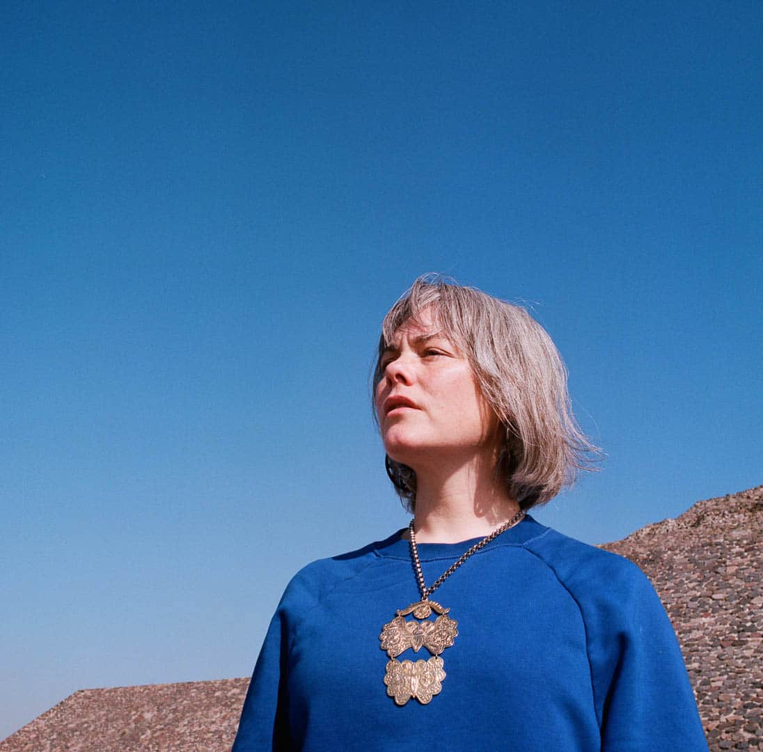 A close up of a woman atop a Teotihuacan pyramid