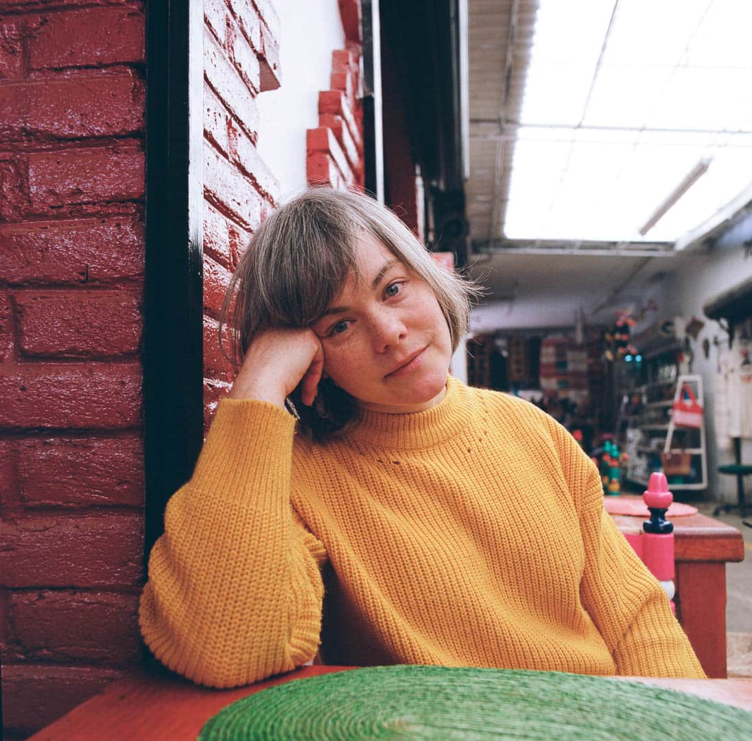 A woman dining at a small market