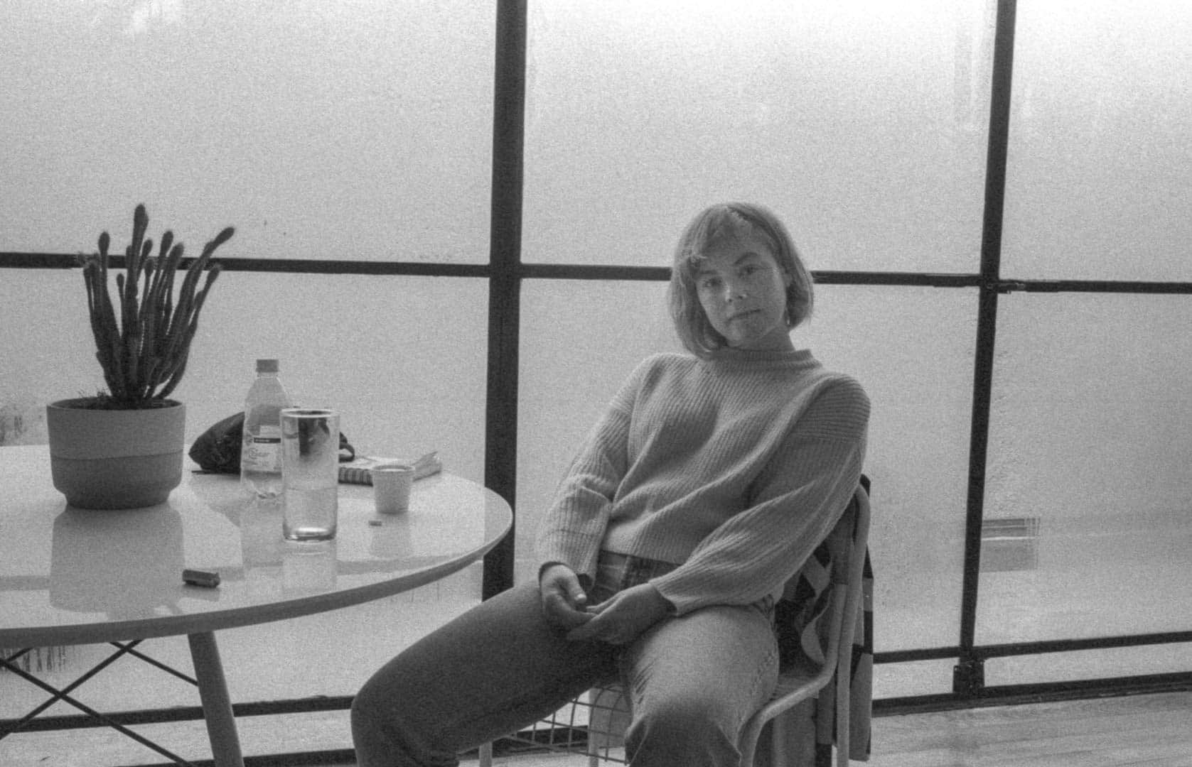 A woman sitting in a relaxed way at a table