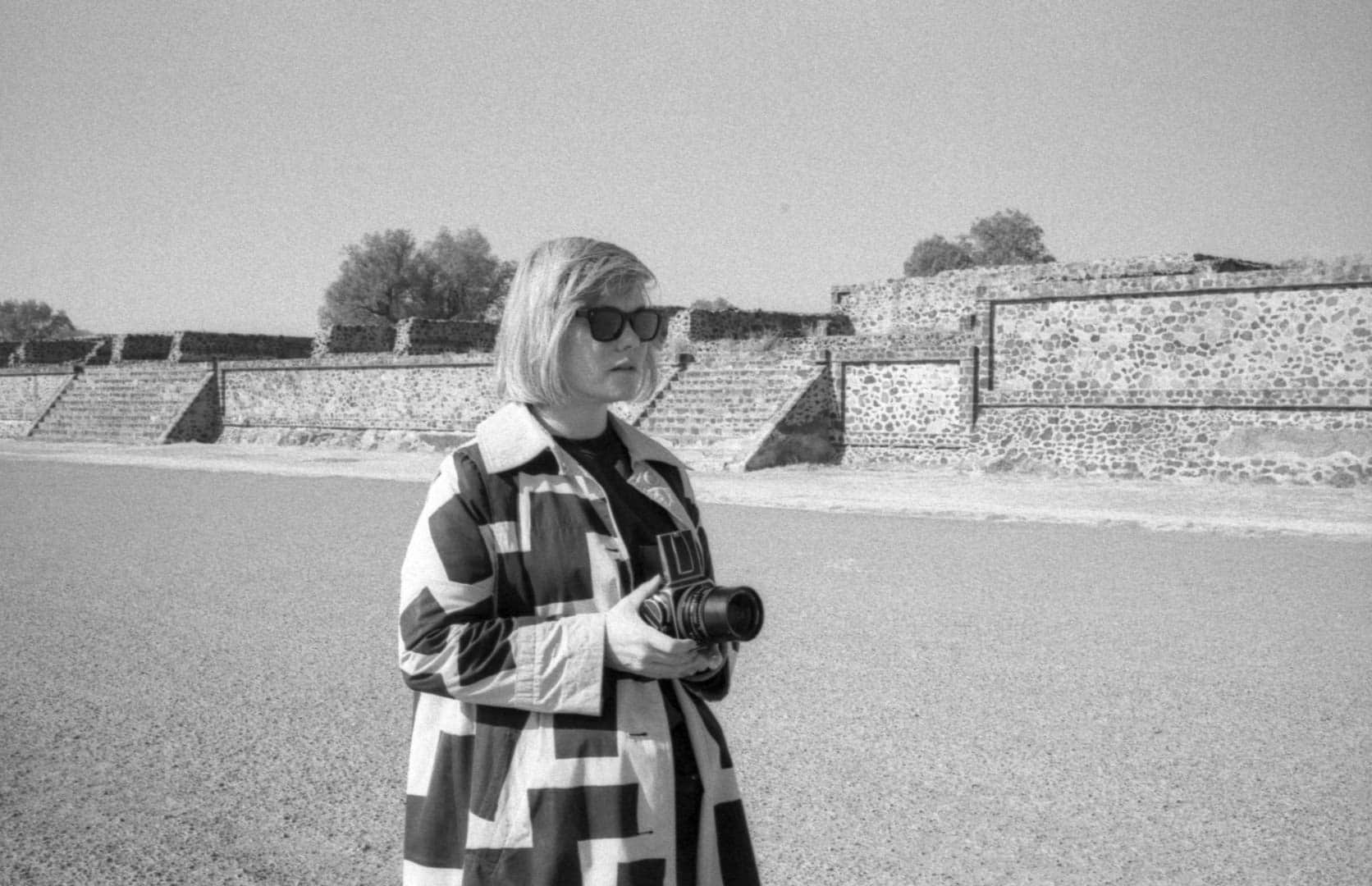 A woman takes a photograph at Teotihuacan pyramid