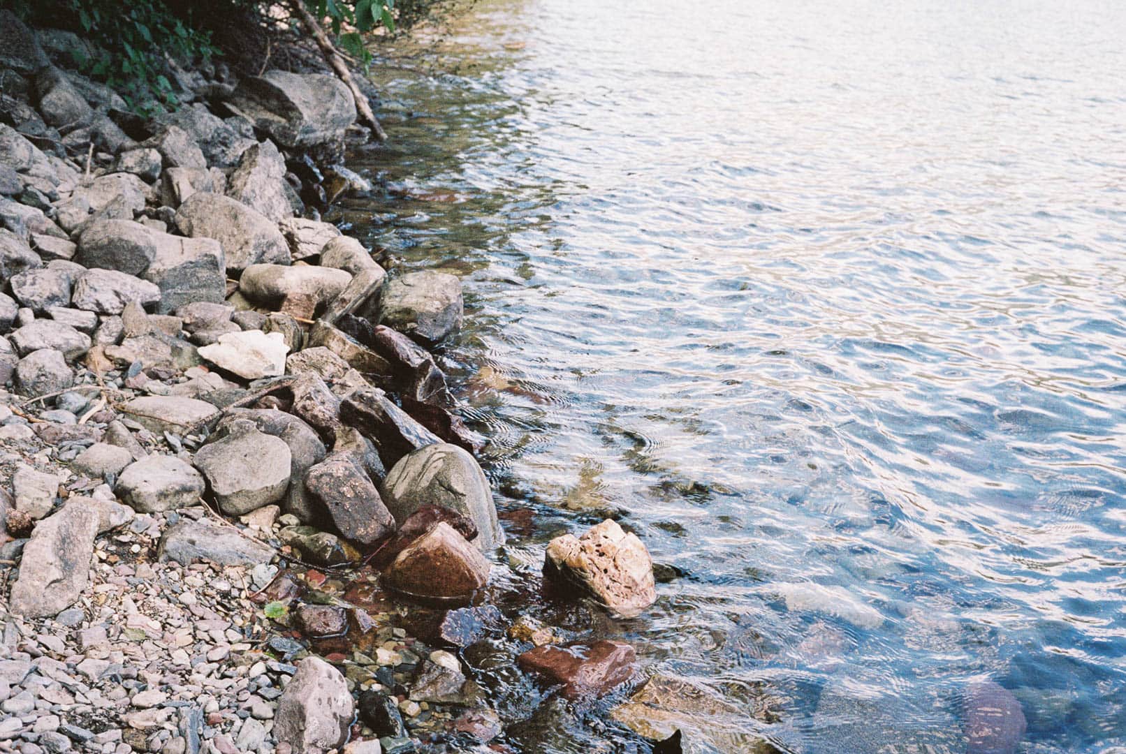 Ripples from a lake against rocks