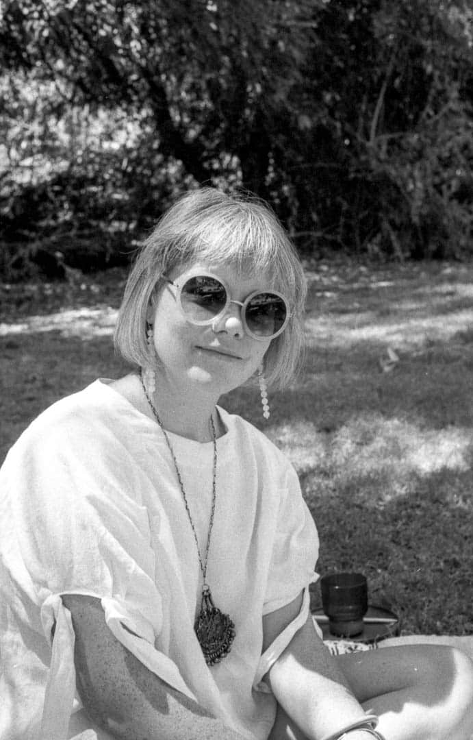 My wife wearing round sunglasses in the park