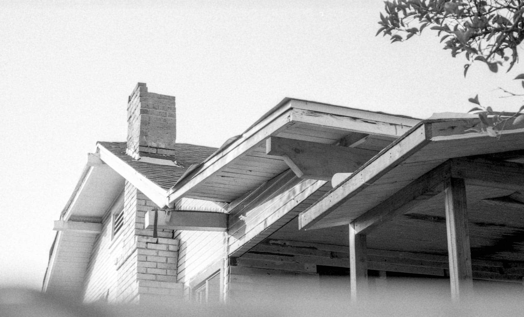 The roofline of a dilapidated house