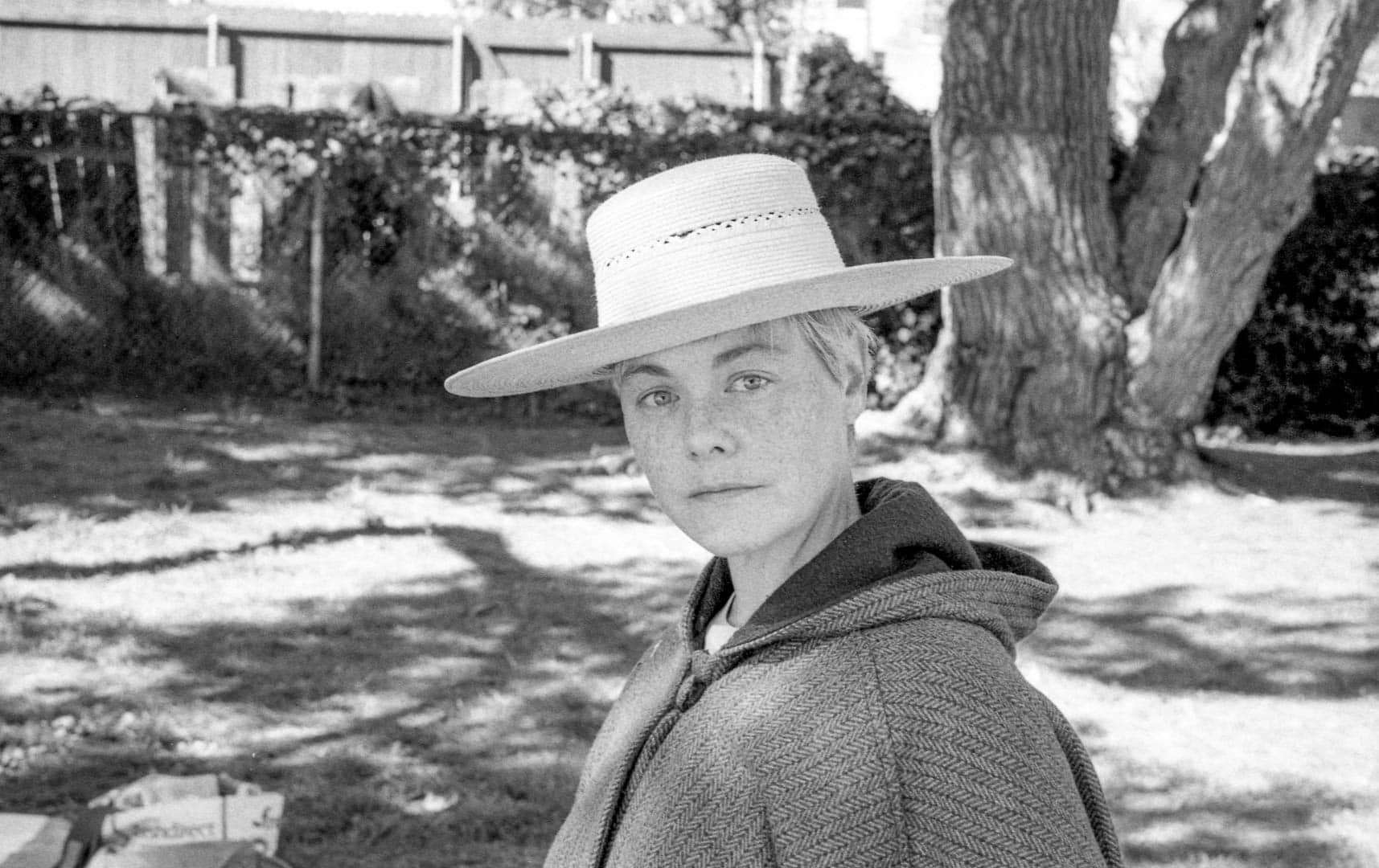 Portrait of my wife in the park wearing a straw hat