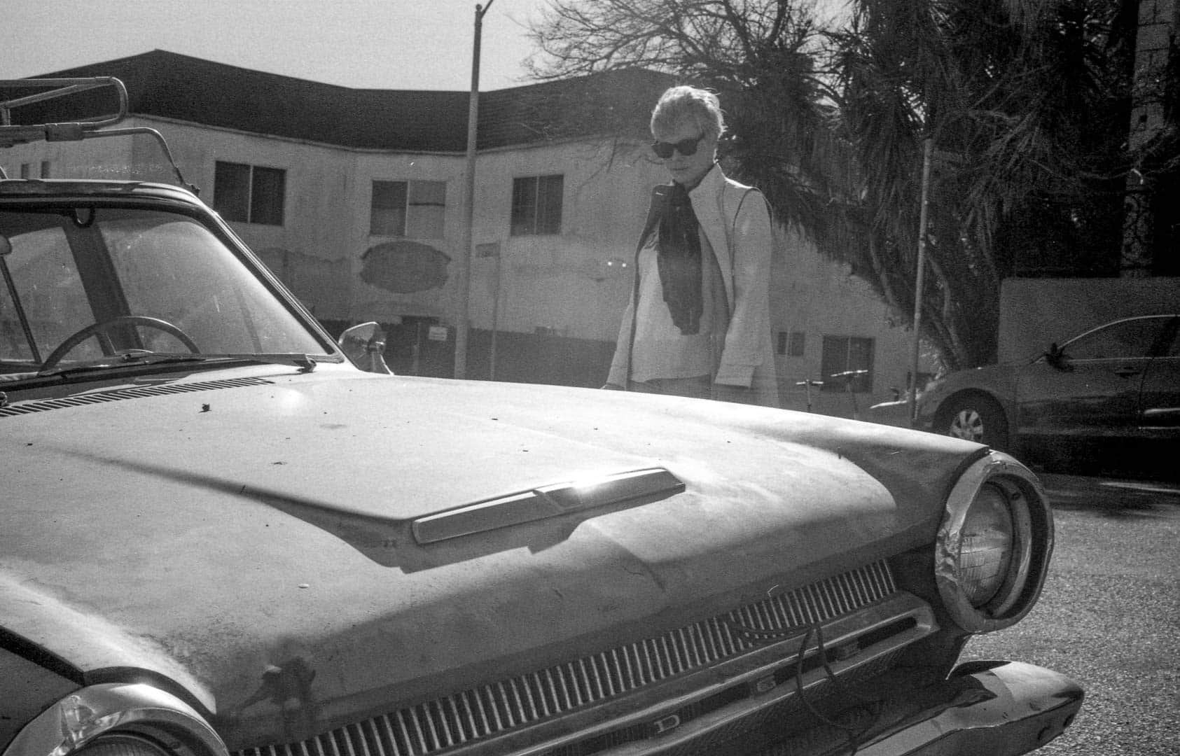 My wife looking down at a classic American car